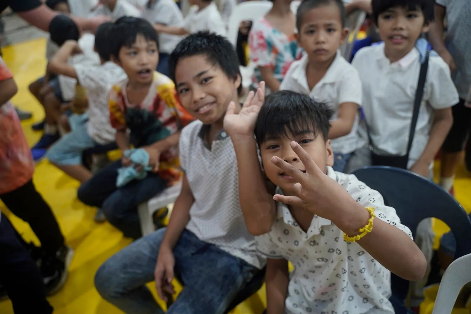 Young boys waving to the camera