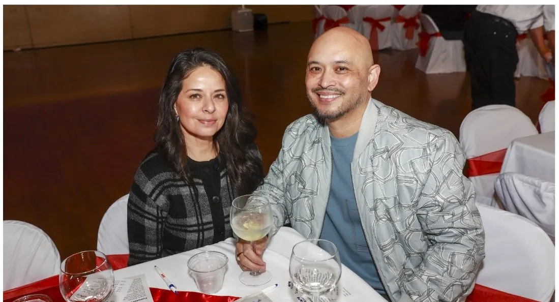 Two guests seated at a decorated dinner table, smiling