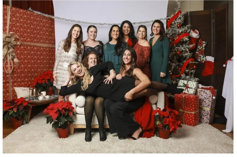 A group of friends posing in the complimentary Christmas portrait studio